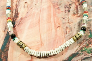 Genuine Gemstones Necklace Featuring Genuine Howlite with Genuine Turquoise, Spiny Oyster Shell Black Onyx and Blue Lapis Accents. Sterling Silver & Gold Fill Barrels. Sterling Cones & Clasp. Created by Navajo Artist Tommy Singer. Signed T. Singer.